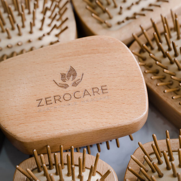 Lightweight detangler brush made from FSC-certified bamboo and natural rubber.