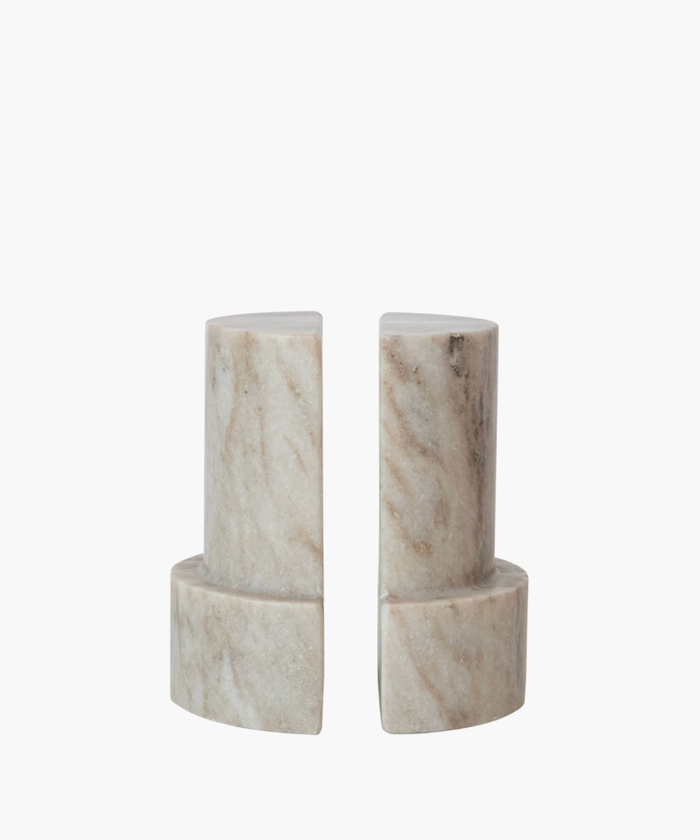 Two beige marble bookends with a semicircular design, placed side by side. Smooth texture with natural stone patterns, conveying elegance and simplicity. | S.W. Home