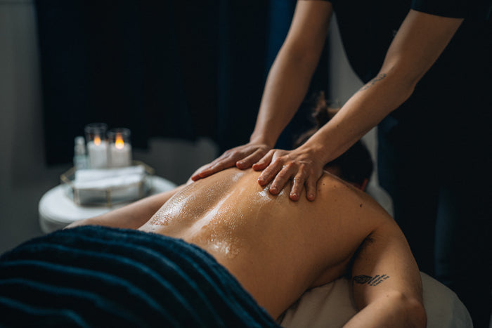 man receiving a body mask treatment