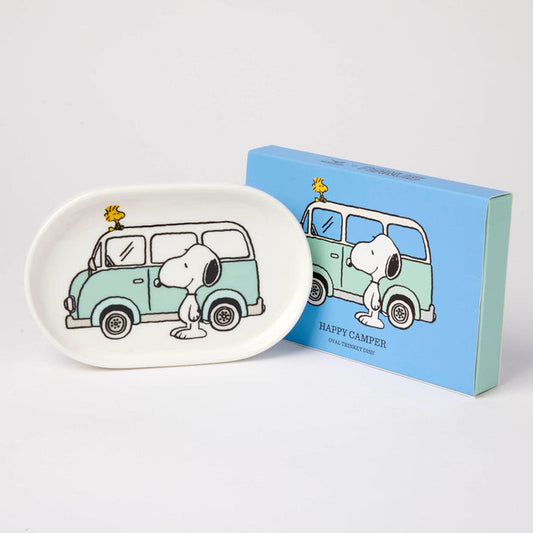 Oval-shaped plate with cartoon design of a van and Snoopy, next to a matching box on a white background.