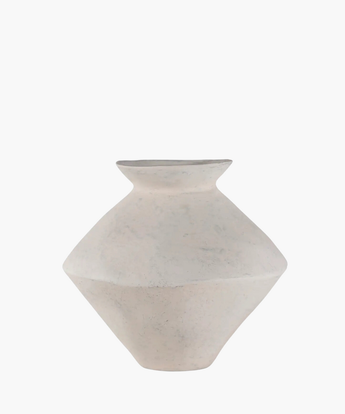 A minimalist, matte white ceramic vase with a wide, flat body and small opening, set against a plain background, conveying simplicity and elegance. | Wildwood Home Co.